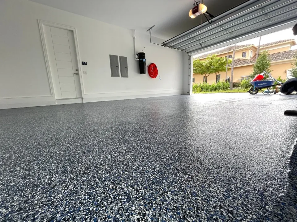 Blue and grey decorative flake floor inside an open garage
