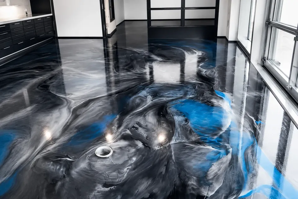 Black and blue decorative coating across a residential garage floor