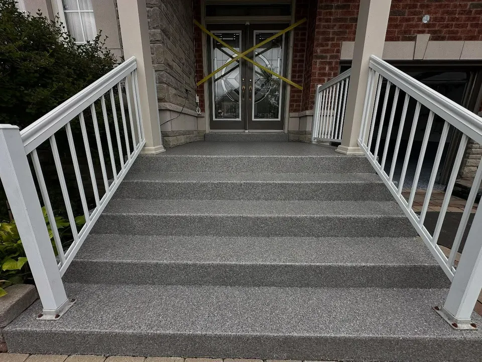 Speckled grey coating on concrete entry steps and porch
