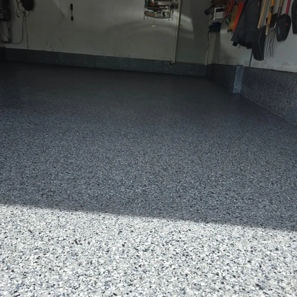 Garage floor with a dark grey speckled coating