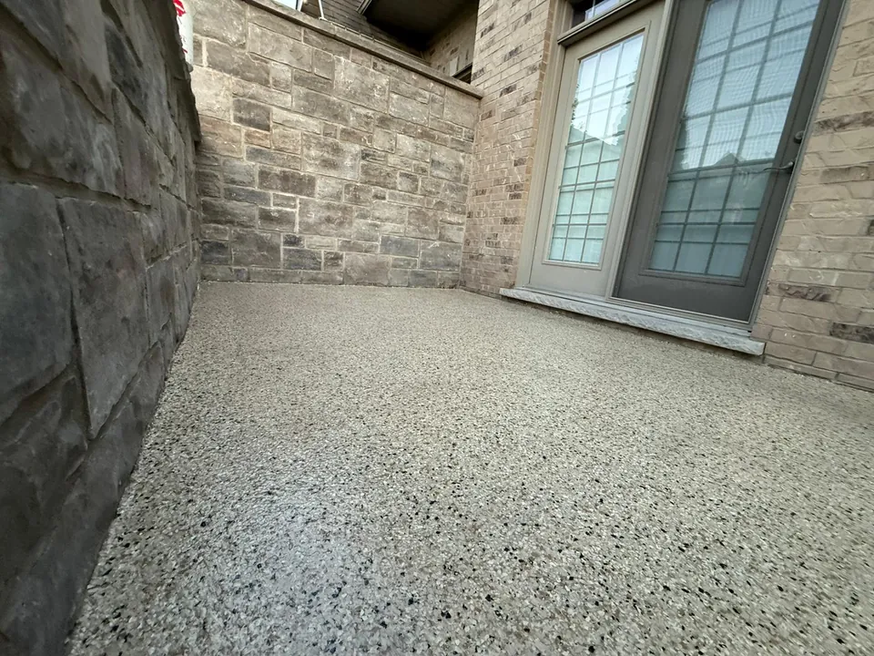 Balcony floor with a tan speckled coating