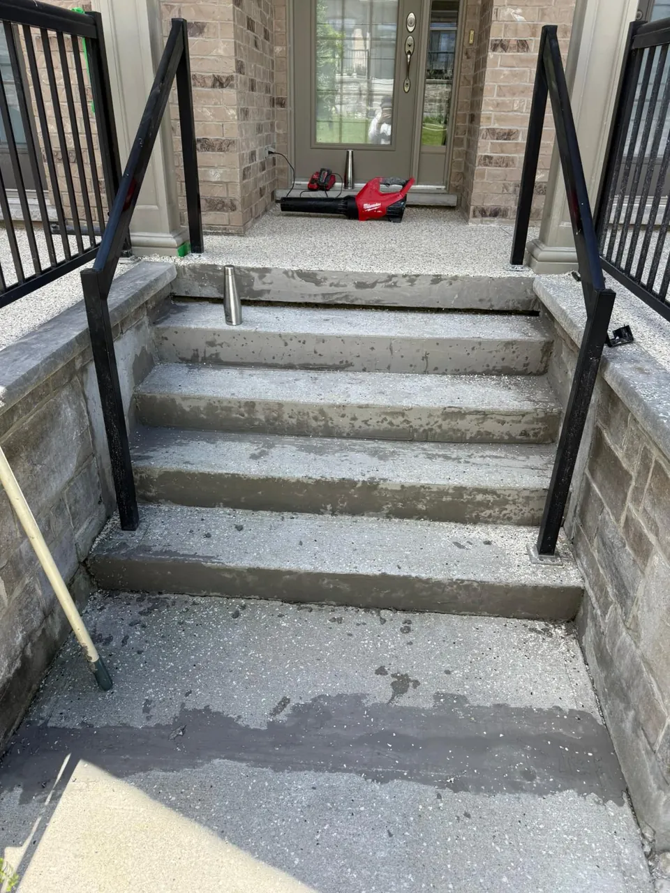 Worn concrete entry steps before coating